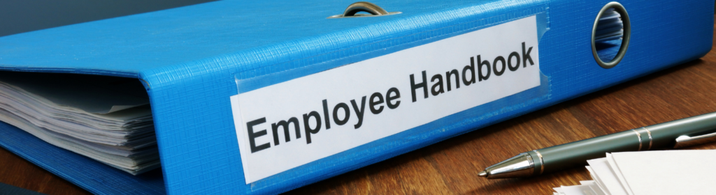 Blue binder labeled "employee handbook"