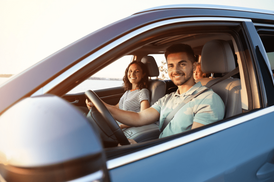 Image featuring happy family driving a car on a summer day for BDI's Auto Insurance